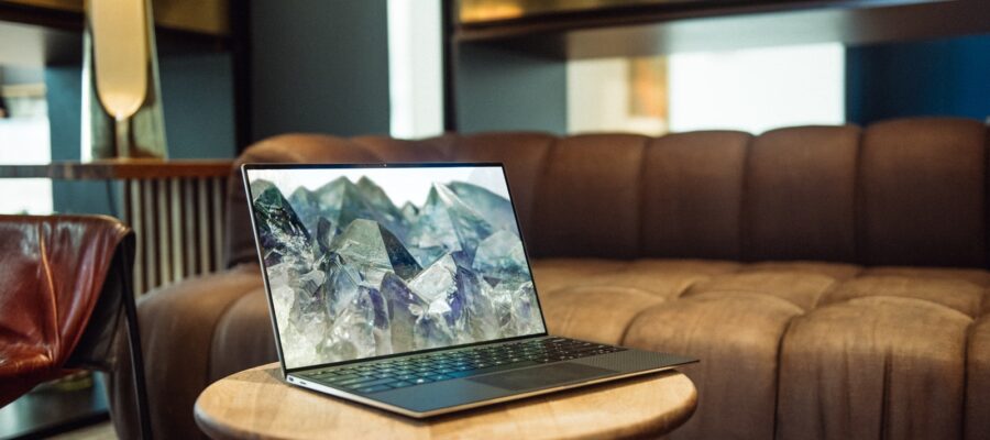 laptop on brown sofa